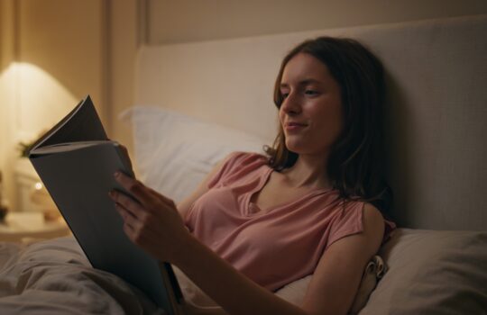 calm-female-holding-book-at-night-closeup-smiling-2024-11-05-02-44-40-utc