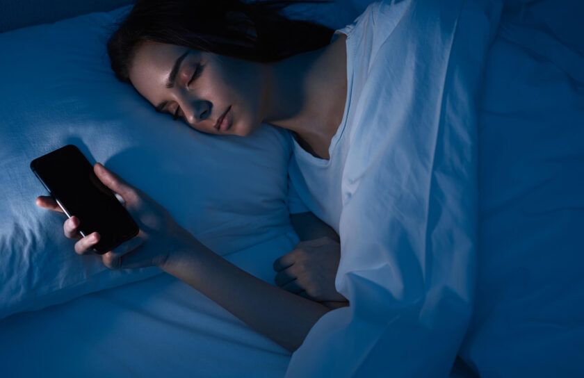 woman-sleeping-with-smartphone-in-bed-2022-11-12-14-58-28-utc (1) (1)
