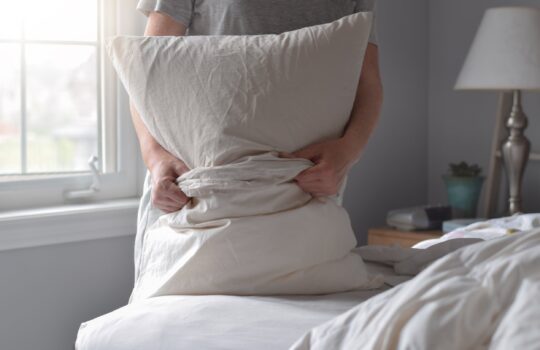 woman-is-putting-pillowcase-on-a-pillow-while-chan-2025-03-12-22-31-27-utc
