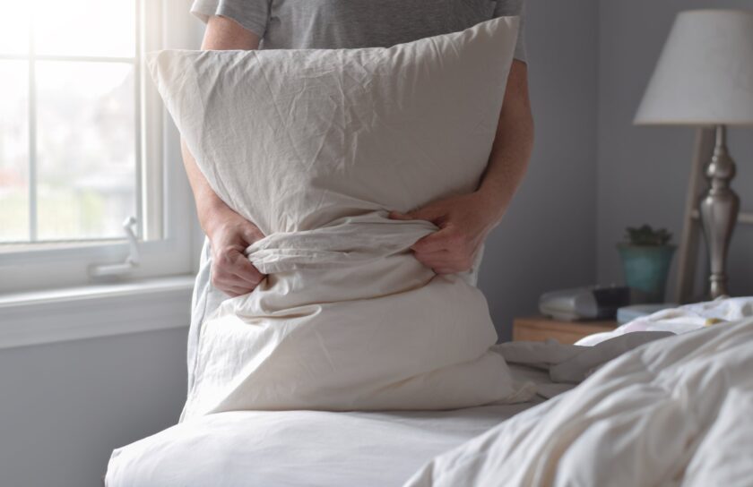 woman-is-putting-pillowcase-on-a-pillow-while-chan-2025-03-12-22-31-27-utc